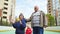 Senior grandfather and grandmother support, hug their grandson who wins goal.