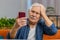 Senior grandfather man use smartphone surprised by bad news, fortune loss, fail, lottery results