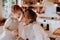 Senior grandmother with small toddler boy making cakes at home, kissing.