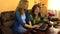 Senior grandmother woman and pregnant granddaughter use laptop