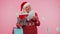 Senior grandmother woman spending money on Christmas holiday holding sale gift boxes, shopping bags