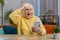 Senior grandmother woman use smartphone surprised by bad news, fortune loss, fail, lottery results