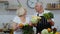 Senior grandparents couple in kitchen. Mature man and woman recommending eating raw vegetable food