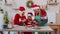 Senior grandparents and grandchild watching cooking lesson using digital tablet at Christmas kitchen