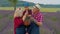 Senior grandparents granddaughter farmers growing lavender plant in garden field, family business