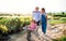 Senior grandparents pushing granddaughter in wheelbarrow when gardening.