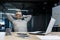 Senior gray haired man resting in office on chair with hands behind head, businessman boss working using laptop, mature