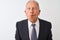 Senior grey-haired businessman wearing suit standing over isolated white background making fish face with lips, crazy and comical