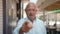 Senior grey-haired man smiling confident doing coming gesture with hand at street