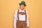 Senior grey-haired man wearing german traditional octoberfest suit over yellow background skeptic and nervous, frowning upset