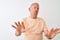 Senior grey-haired man wearing striped t-shirt standing over isolated white background Moving away hands palms showing refusal and