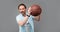 senior grizzled man with basketball ball on grey background, sport