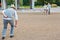 Senior group playing boule in a city