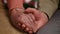 Senior hands of woman and man holding in front of christmas lights