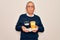 Senior handsome hoary man holding tray with takeaway cups of coffee over white background with a confident expression on smart