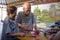 Senior happy and beautiful retired Asian Japanese couple cooking together at home kitchen enjoying preparing meal relaxed in aged