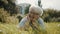 Senior happy gray haired woman enjoying the sunny autumn day in the park