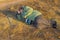 Senior hiker has short rest lying on the roadside