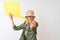 Senior hiker woman wearing canteen holding speech bubble over isolated white background pointing with finger to the camera and to