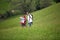 Senior hikers looking at map standing in meadow