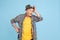 Senior hipster man in stylish hat isolated on blue background. Tech and joyful elderly lifestyle concept