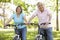 Senior Hispanic Couple Cycling In Park