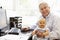 Senior Hispanic man with computer and baby