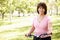 Senior Hispanic woman with bike