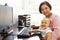 Senior Hispanic woman with computer and baby