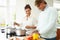 Senior Indian Couple Cooking Meal At Home