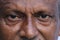 Senior Indian man`s eyes and wrinkles on skin close view.