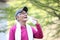 Senior Japanese man sweaty and thirsty after exercise drinks water outside