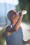 Senior jogging man drinking fresh water from bottle