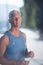 Senior jogging man drinking fresh water from bottle