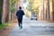 Senior jogging to keep fit on the tree-lined street