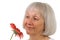 Senior Lady Enjoys A Red Daisy Flower