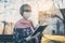 Senior lady with face mask reading the bible in front of a church