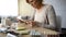 Senior lady reading instruction, pills blisters lying on table, elderly disease