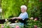 Senior lady in rose garden