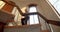 senior lady on steps holding her hand as they descend a set of wooden stairs outdoors on the care home.