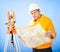 Senior land surveyor with theodolite