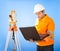 Senior land surveyor with theodolite