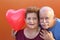 Senior Latino Couple holding a heart balloon