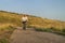 Senior male cyclist is riding a touring bike on a gravel trail