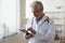 Senior male doctor using digital tablet providing online healthcare services