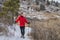 senior male hiker with trekking poles in winter landscape of Colorado foothills