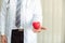 Senior male medicine doctor holding heart on abstract background., Close-up portrait of professional doctor giving red heart toy