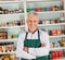 Senior Male Owner Smiling At Supermarket