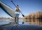 senior male paddler is launching a stand up paddleboard on a calm lake