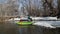 Senior male paddler is paddling and landing inflatable kayak